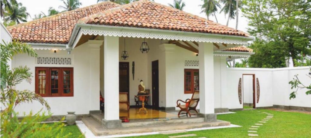 a white Villa with a red tile roof