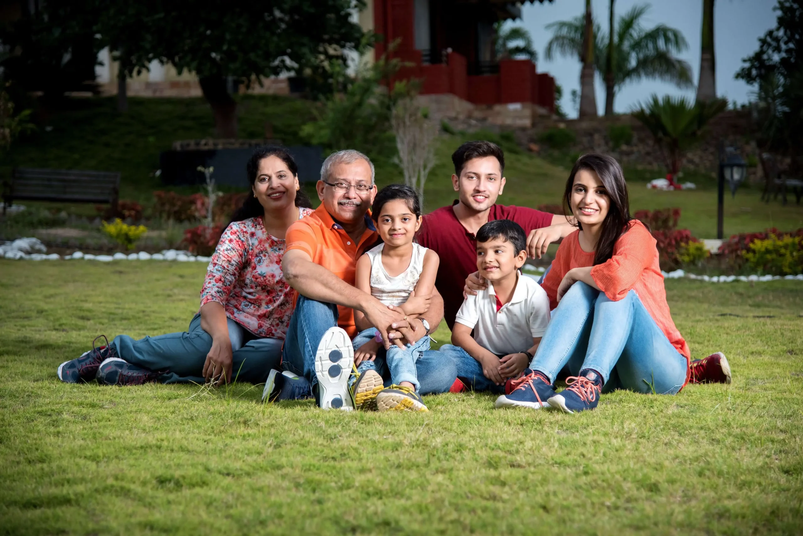 a group of people sitting on grass